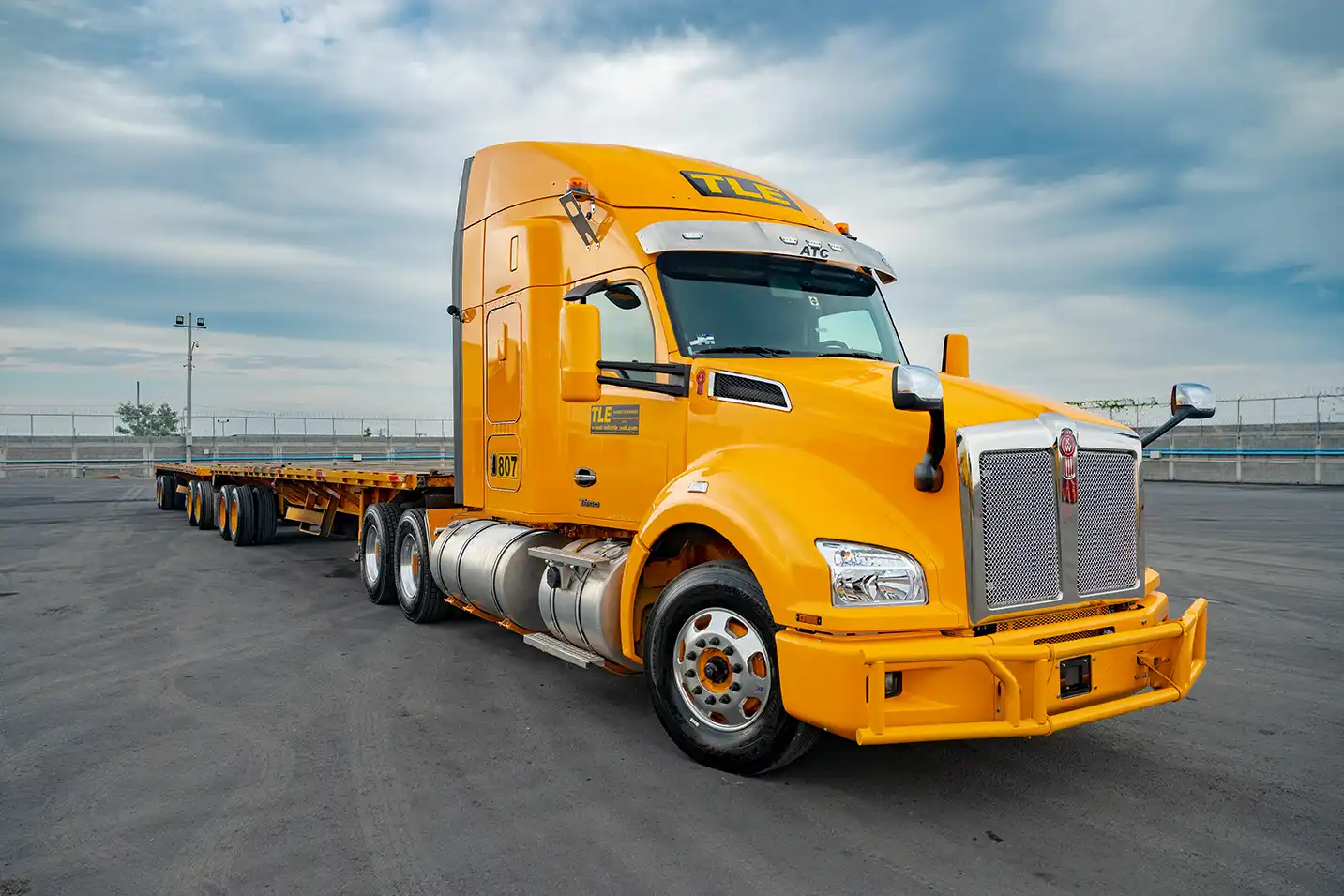 TLE tractor-trailer with a flatbed in a maneuvering yard